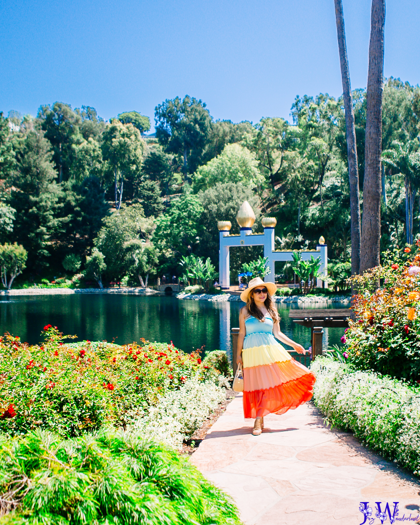 Girl wearing colorblock dress walking at the lake at The Golden Lotus Archway at the Self-Realization Fellowship Lake Shrine