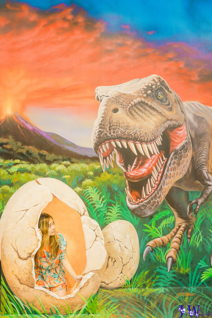 The girl is hiding inside a dinosaur egg while the dinosaur is looking for her at #3DAR Trick Art Museum in Santa Monica